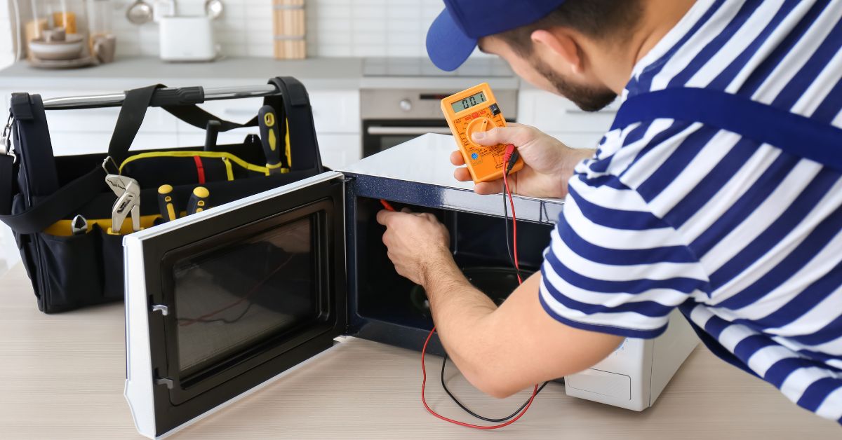 repairmain-is-repairing-a-microwave-in-a-household