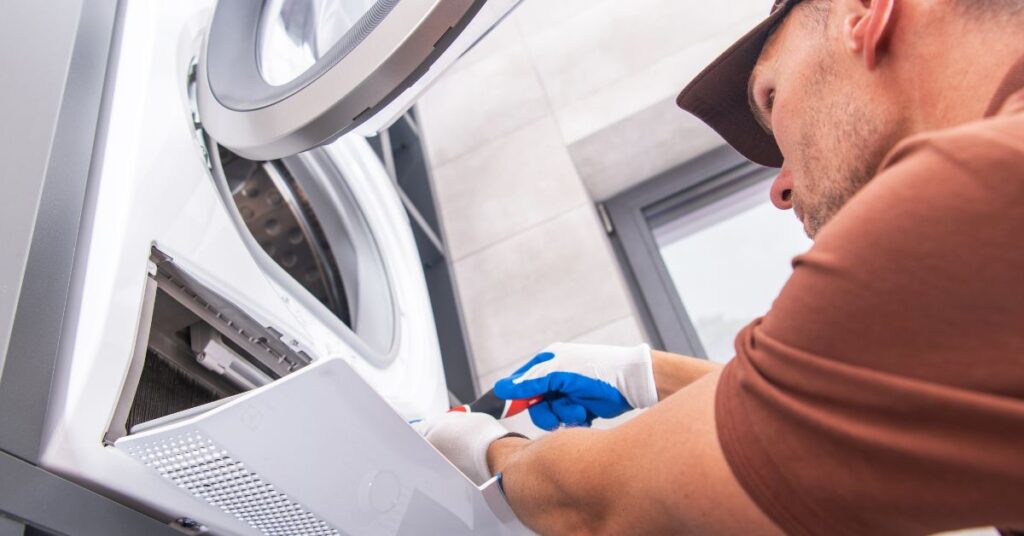  a repairman is trouble shooting a dryer