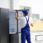 repairmain-is-repairing-a-refrigerator-in-a-household