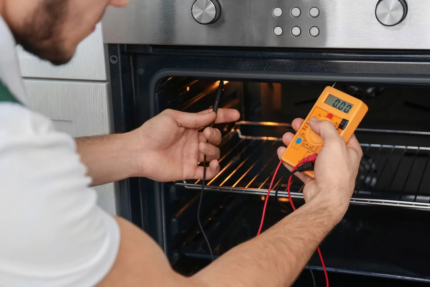 repairman-is-repairing-an-oven-in-a-house