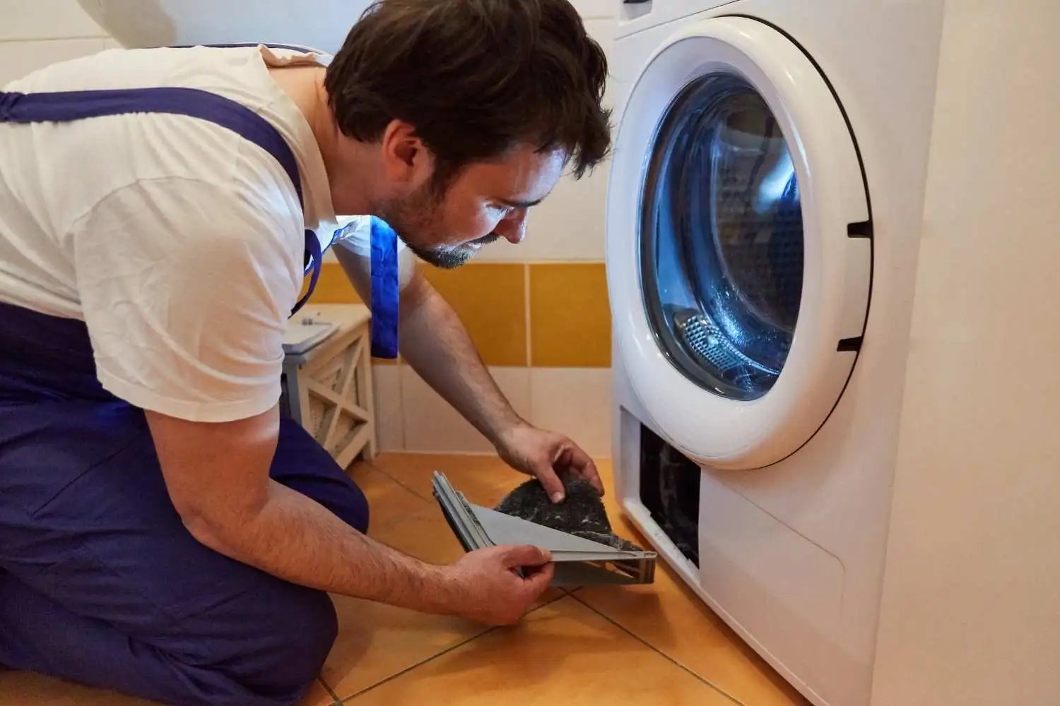 repairmain-is-repairing-a-dryer-in-a-household