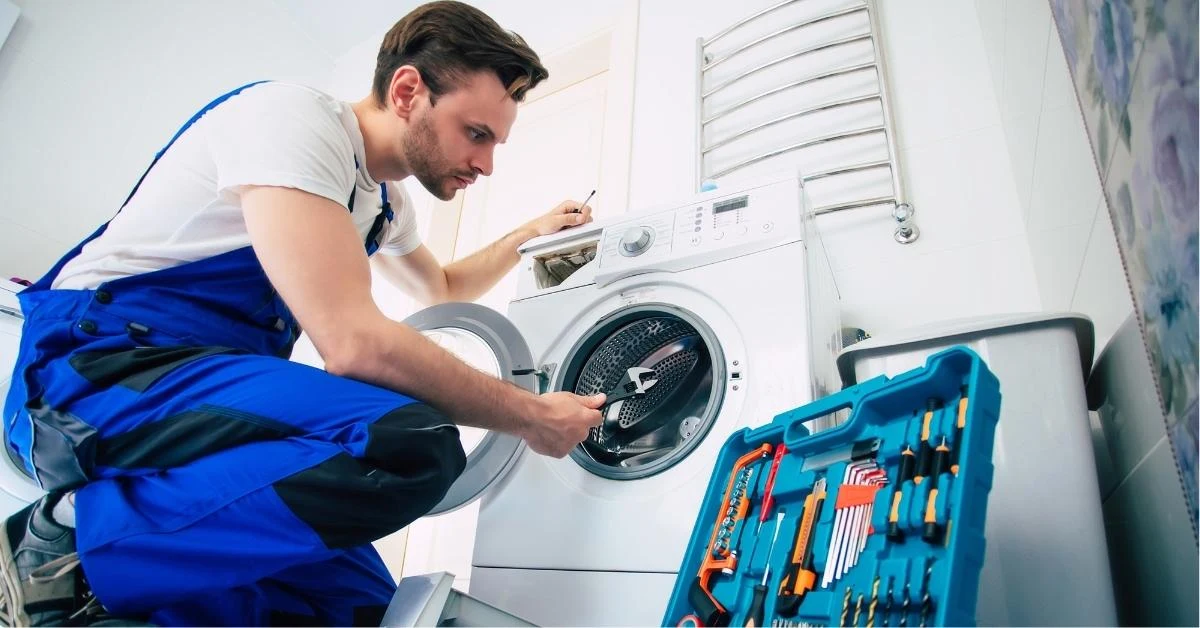technician-fixing-washing-machine-with-tools