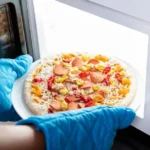 a-person-is-baking-pizza-in-a-microwave
