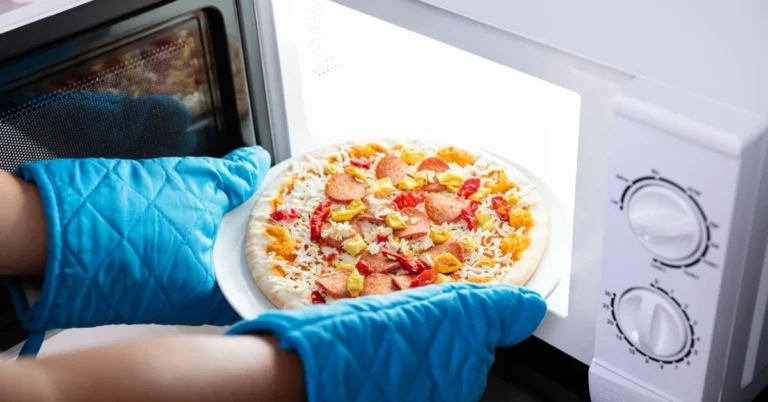 a-person-is-baking-pizza-in-a-microwave